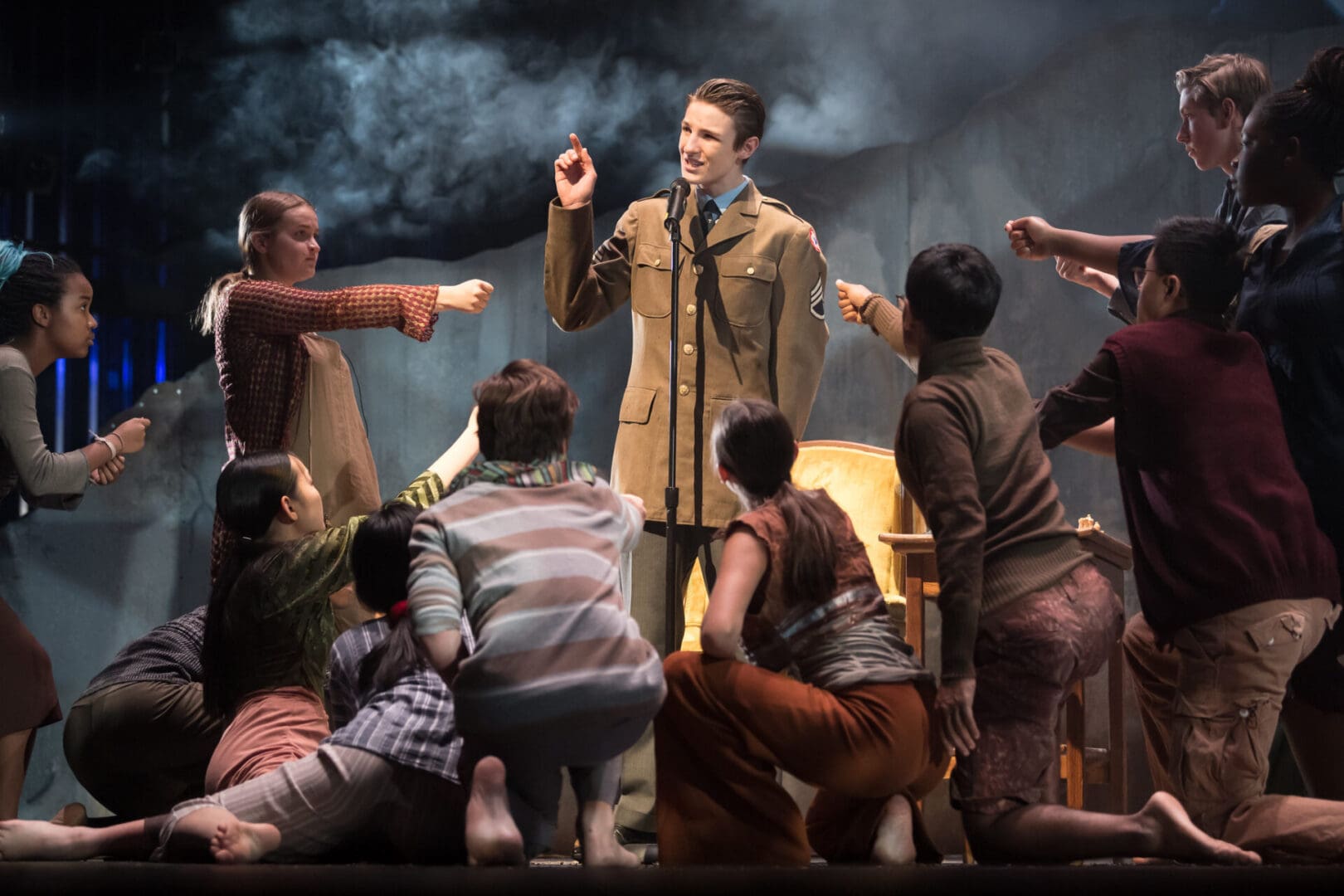 A group of people on stage with a man in a military uniform, showcasing the quintessential New England charm of Groton, Massachusetts.