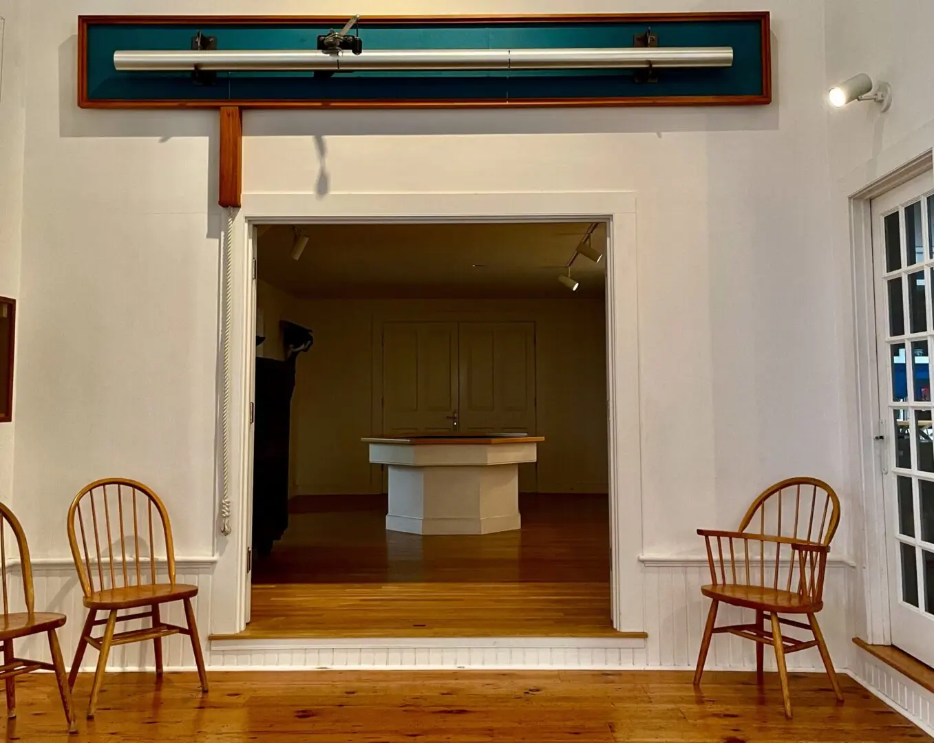 A room with two chairs and a wooden floor.