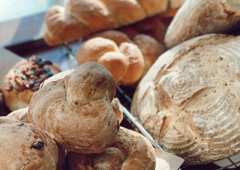 A variety of breads in a basket on a table, highlighting the quintessential New England charm of Groton Massachusetts.